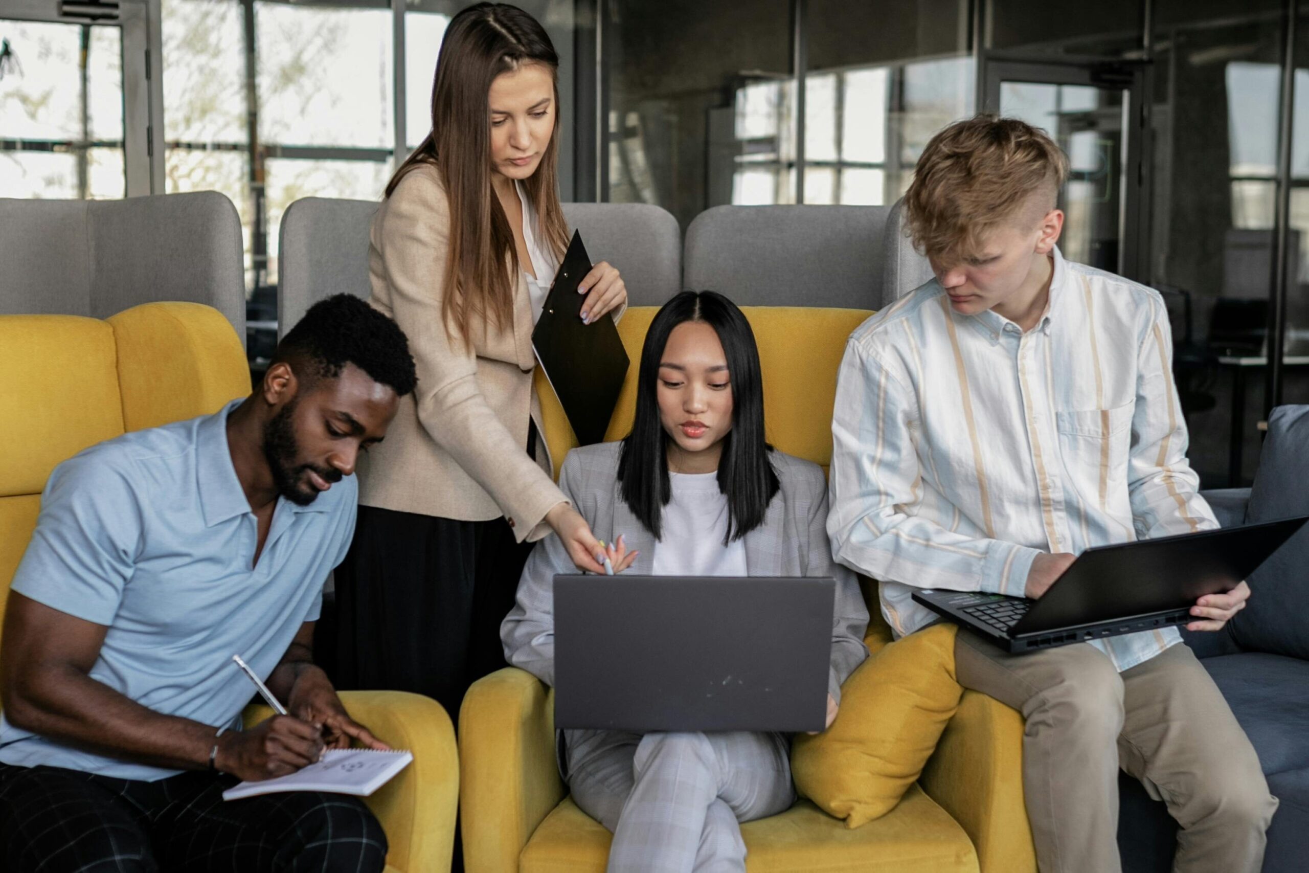 A diverse group of coworkers engaged in a collaborative meeting in a modern office space.